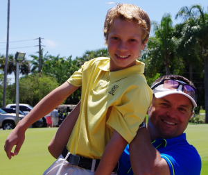 Joe Alfieri lifts his son Cade, 13, after winning the FSGA Mid-Amateur Championship on Sunday.  Photo by Bill Van Smith..JPG